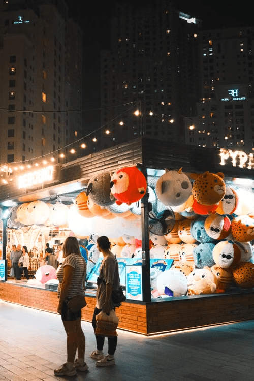 Festival booth with prizes and string lights at night