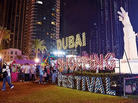 Dubai Shopping Festival neon sign with skyline at night