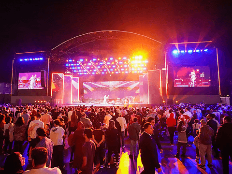 Concert crowd in front of a lit stage at night
